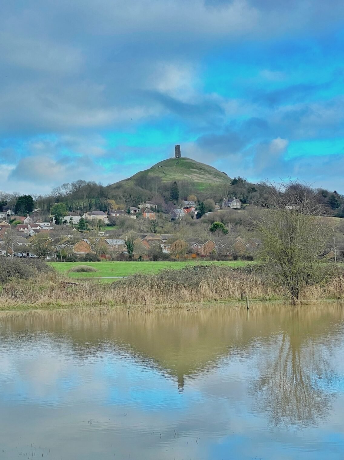 View of Glastonbury Tor surrounded by water somerset and the levels
