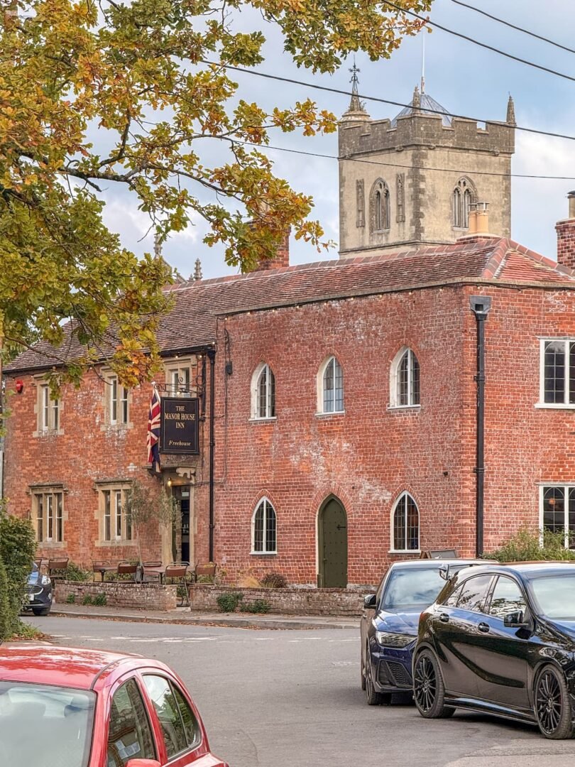Manor House Inn Ditcheat and church, Somerset UK